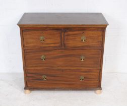 A Georgian mahogany chest of four drawers, of small proportions, raised on replacement bun feet -