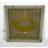A vintage double sided wooden advertising sign for "The Bull Hotel". Shows signs of wear