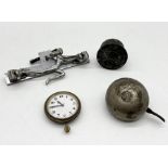 A collection of items including chrome car mascot, Lucas King of the Road bell, Swiss made car clock