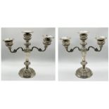 A pair of hallmarked silver three branch candelabra