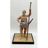 A Japanese Hakata clay figure of a Samurai on wooden base