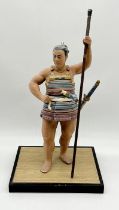 A Japanese Hakata clay figure of a Samurai on wooden base