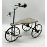 A small plant stand in the form of tricycle