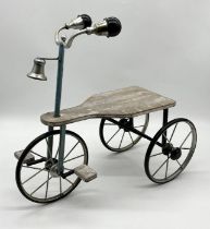 A small plant stand in the form of tricycle