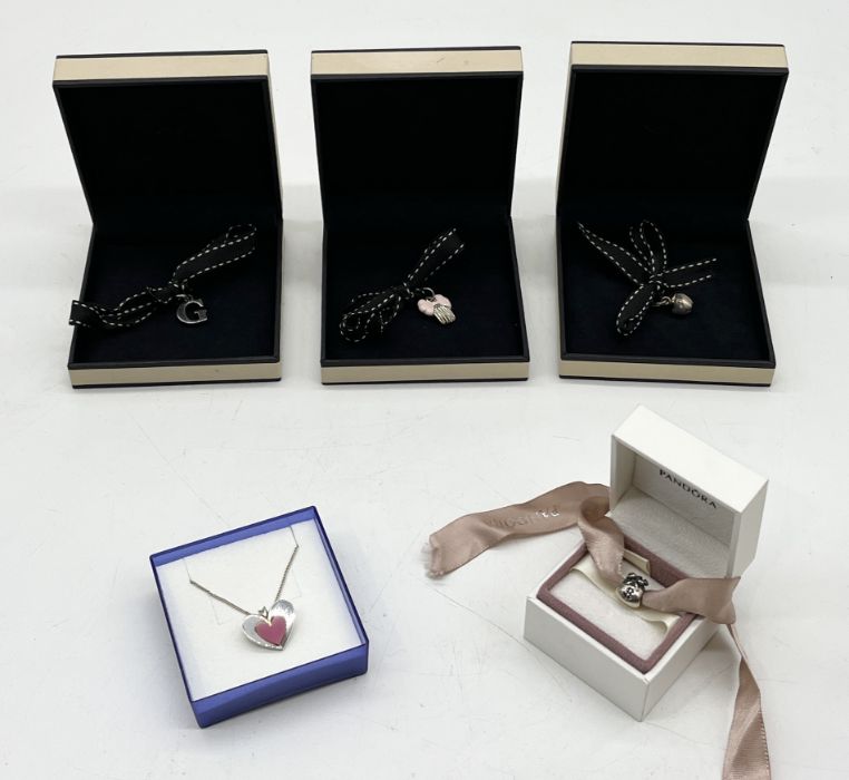 Four Links of London boxed charms, a boxed Pandora charm and a silver heart shaped pendant