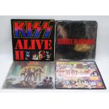 A collection of four Kiss vinyl records, comprising 'Alive II', 'Double Platinum', 'Love Gun' and '