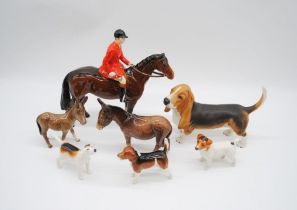 A collection of Beswick including donkeys, Jack Russell, huntsman (A/F), Bassett Hound etc.