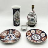 A collection of Oriental china including cylindrical Chinese vase, two Imari plates, lamp etc.