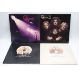 A collection of four Queen vinyl records, comprising 'Queen', 'Queen II', 'A Night At The Opera' and