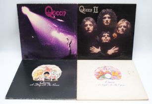 A collection of four Queen vinyl records, comprising 'Queen', 'Queen II', 'A Night At The Opera' and