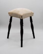 A four legged stool, in need of reupholstering