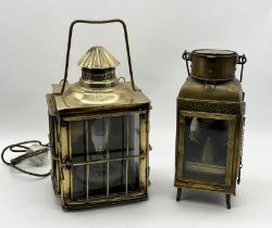 Two brass ships lanterns one larger example with grill surround and the other a storm lamp