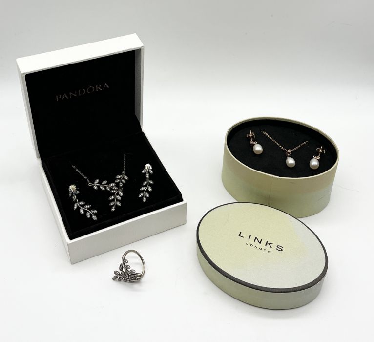 A set of Pandora 925 silver jewellery including pendant on chain, earrings and ring along with a