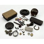 An assortment of various items including miniature brass plane brooches, stopwatch, fishing reel