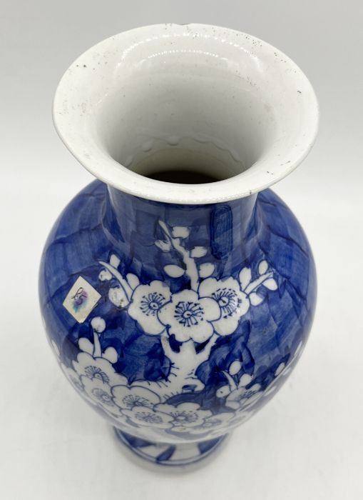 A Chinese blue and white vase with floral decoration along with a saucer - Image 3 of 5