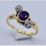 An 18ct gold ruby and diamond three stone ring