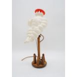 A vintage Michelin man lamp with table skittle base - height 46cm