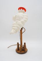 A vintage Michelin man lamp with table skittle base - height 46cm