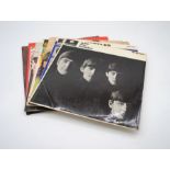 A collection of seven 12" vinyl records by The Beatles, including 'With The Beatles', 'A Hard Days