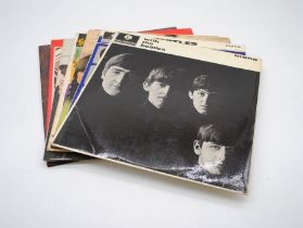 A collection of seven 12" vinyl records by The Beatles, including 'With The Beatles', 'A Hard Days