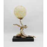 An Art Deco lamp on marble base in the form of a nude lady with mottled spherical glass shade -