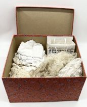 A collection of various vintage lace and fabric including an antique wedding dress with button