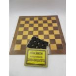 A cased set of draughts along with a board