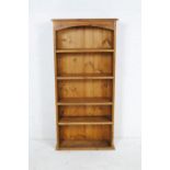 A narrow pine freestanding bookcase - length 61cm, depth 22cm, height 129cm