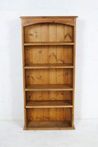 A narrow pine freestanding bookcase - length 61cm, depth 22cm, height 129cm