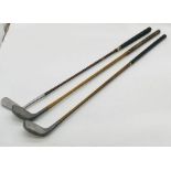 Two vintage Standard Golf Company (Sunderland) Braid-Mills flat lie golf clubs, along with one