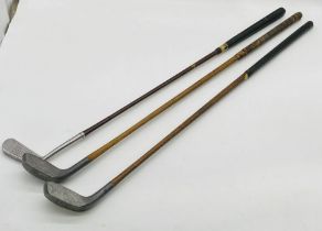 Two vintage Standard Golf Company (Sunderland) Braid-Mills flat lie golf clubs, along with one