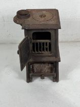 A cast iron wood burning stove, possibly railway related. Height 56cm.