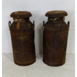 Two vintage weathered lidded milk churns - one lid marked UCL Trowbridge