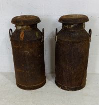 Two vintage weathered lidded milk churns - one lid marked UCL Trowbridge