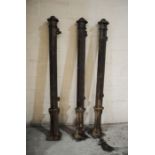 Three weathered cast iron gate posts, marked 'Paragon Eng Co, Bridport' - height 183cm