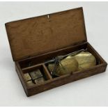 A small wooden cased set of brass scales with set of weights
