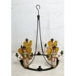 A wrought iron hanging candelabra decorated with four Nuremberg style folk art angels