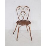A well weathered metal garden chair