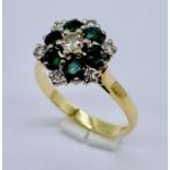 An 18ct gold diamond and emerald cluster ring