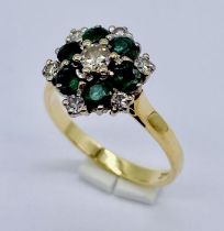 An 18ct gold diamond and emerald cluster ring