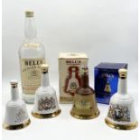 A collection of ceramic decanters including Wade, Bell's etc. along with an oversized Bells Whisky