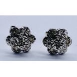A pair of 9ct white gold earrings set with diamonds