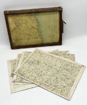 A collection of vintage motoring maps mounted on board contained within a leather case