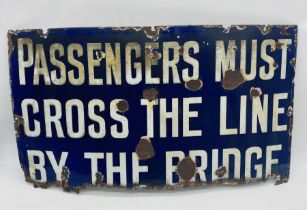 A railway related enamelled sign " Passengers Must Cross The Line By The Bridge" - Overall size 43cm