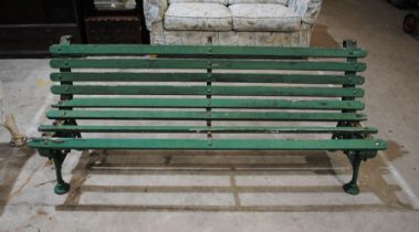 A 19th century weathered green painted cast iron garden bench, marked 'Cataward & Son, Hitchin' with