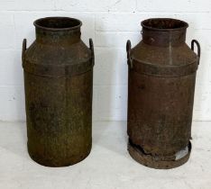 Two weathered milk churns, one with damage to the bottom as shown