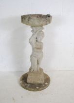 A reconstituted stone sectional bird bath with cherub decoration - height 98cm