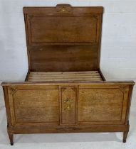 A walnut French double bed with classical gilded decoration.