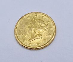 A United States liberty head gold dollar coin dated 1852 - weight 1.6g