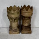 A pair of weathered buff terracotta chimneys. Height 77cm